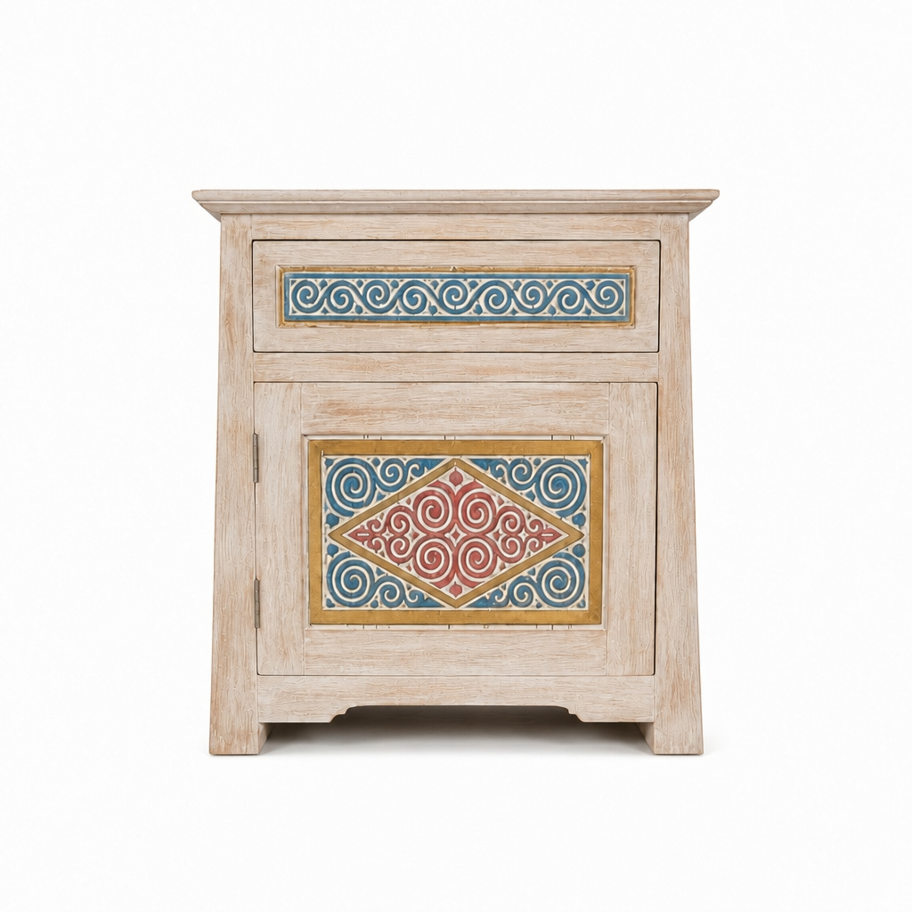 A small rustic wooden nightstand with a distressed light beige finish, featuring a single drawer and a lower cabinet door, both decorated with colorful hand-painted geometric and scroll patterns in blue, red, and gold.